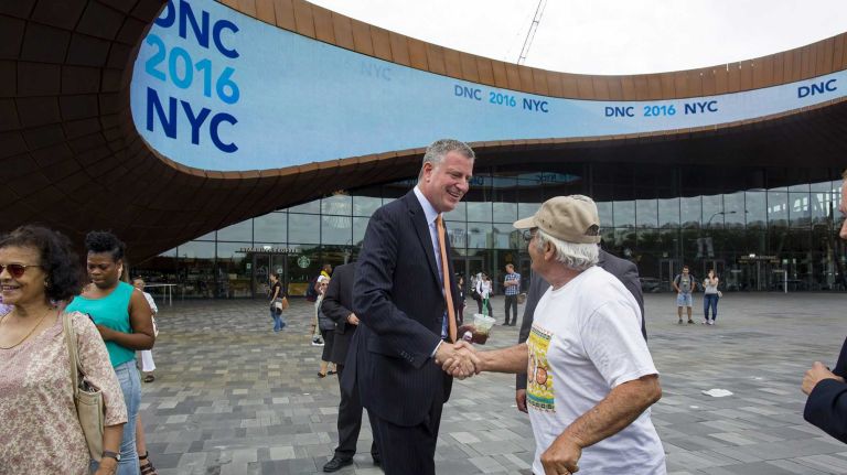 Mayor Bill de Blasio greets a passerby after a news conference at the Barclay's Center Tuesday, Aug. 12, 2014, where he discussed New York City's bid for the Democratic National Convention.