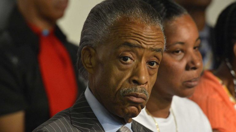 The Rev. Al Sharpton is seen alongside of Esaw Garner, 46, on stage at the National Action Network in Harlem on Saturday, Aug. 9, 2014. 
