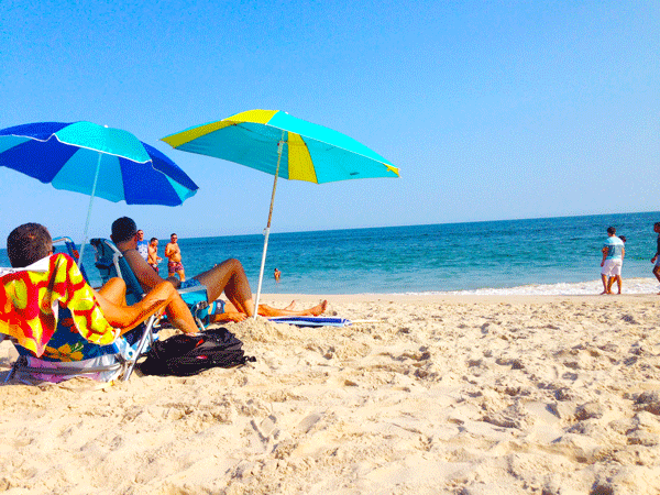 West Village residents enjoy a quiet summer weekend on the beach in Fire Island Pines.   Photo by Troy Masters