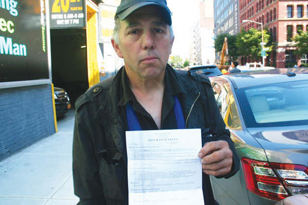 Jimmy Tarangelo showing proof that Spot had been receiving veterinary care: the dog’s July 25 discharge sheet from the ABC Animal Hospital, in the East Village.