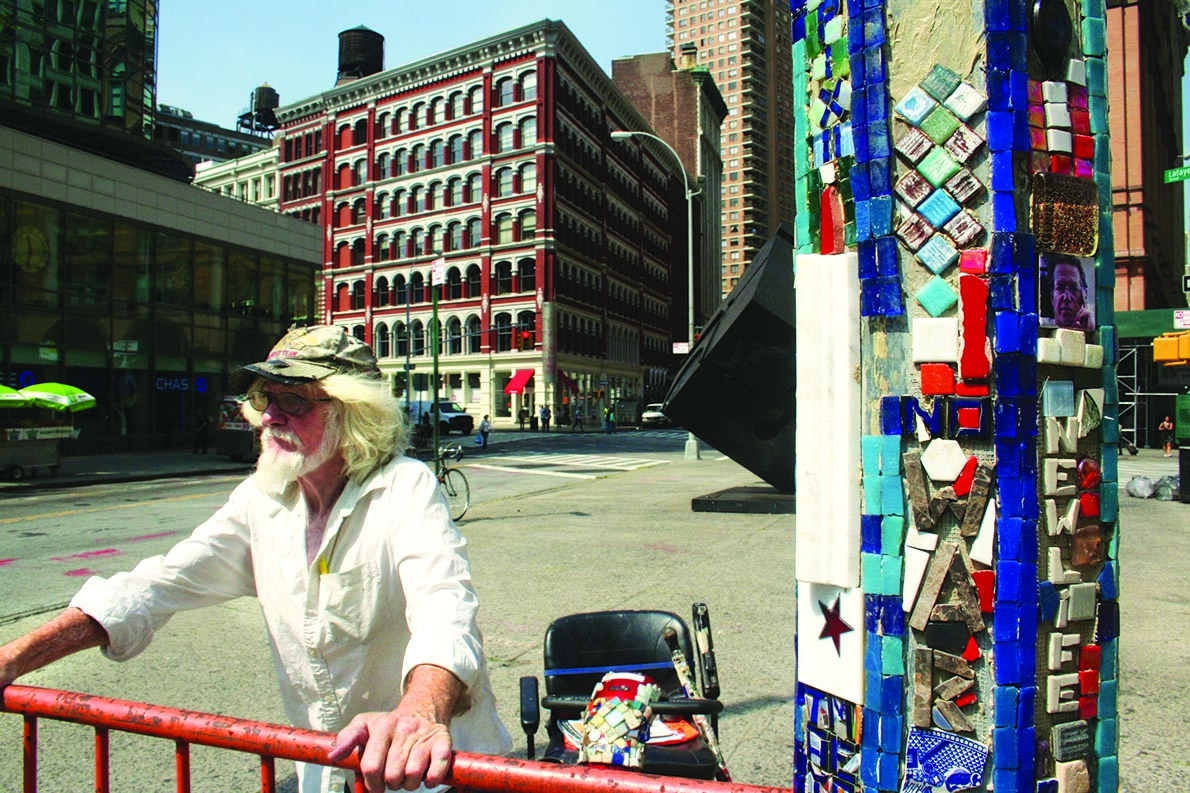 Mosaic Man, BID try to piece together pole project 2 Jim Power stood sentinel over his “Mosaic Trail” lampposts at Astor Place. Parked in the background is his tile-encrusted “Mosaic-mobile.” File photo by Yannic Rack