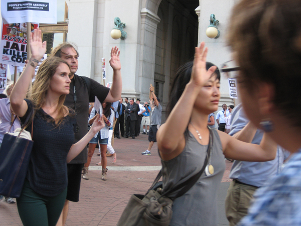 Protesters demand arrest in Ferguson shooting 1 Downtown Express photo by Dusica Sue Malesevic The demonstrators marched with their hands held up in surrender. Witnesses say Michael Brown had held up his hands before he was fatally shot by a Ferguson police officer.