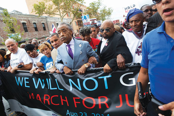 Reverend Al Sharpton, center, led the Aug. 23 protest and march on Staten Island over Eric Garner’s death while being arrested by police.  Photo by Q. Sakamaki