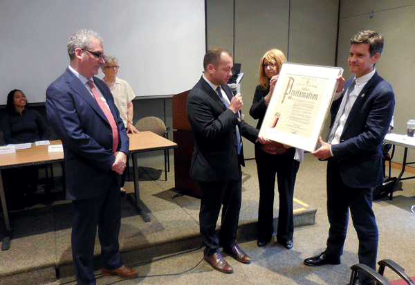 Photo by Eileen Stukane Presentation of City Councilmember Corey Johnson’s Council Proclamation honoring the exit of “inscrutable” CB4 District Manager Bob Benfatto. Foreground, L to R: Benfatto, Johnson, Assemblymember Linda Rosenthal, NY State Senator Brad Hoylman.