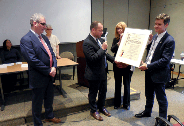 Homes and Rights Highlighted at CB4 Meeting 1 Photo by Eileen Stukane Presentation of City Councilmember Corey Johnson’s Council Proclamation honoring the exit of “inscrutable” CB4 District Manager Bob Benfatto. Foreground, L to R: Benfatto, Johnson, Assemblymember Linda Rosenthal, NY State Senator Brad Hoylman.