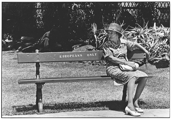 There were no “blacks only” benches in Johannesburg — blacks sat on the curbstones. Gelatin silver print | 8 5/8 x 12 5/8 in. (22 x 32 cm).  © The Ernest Cole Family Trust/ Courtesy the Hasselblad Foundation