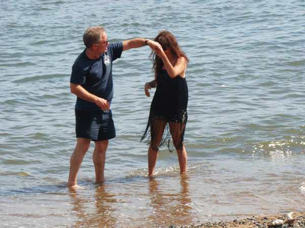 They love that dirty water: Rev. Jen and CC John are cleansed, spiritually at least, by a dip in the East River.  Photo by John T. Foster