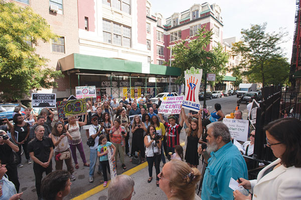 At Sunday’s victory rally, CHARAS’s Chino Garcia spoke to the crowd gathered in front of the group’s former home, the old P.S. 64.   Photo by Roberto J. Mercado