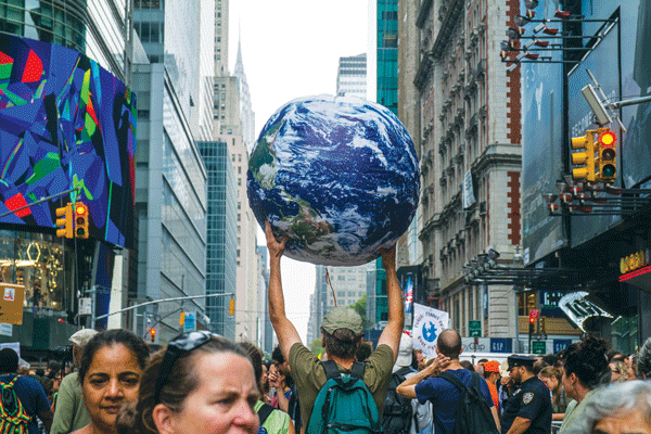He’s got the whole world in his hands — at Sunday’s People’s Climate March.   Photo by Milo Hess