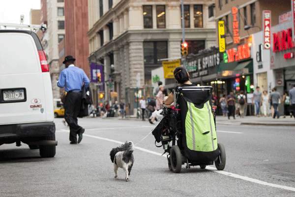 A disabled woman rode her wheelchair for a block along Broadway because she couldn’t access the sidewalk at Astor Place.    Photo by Zach Williams
