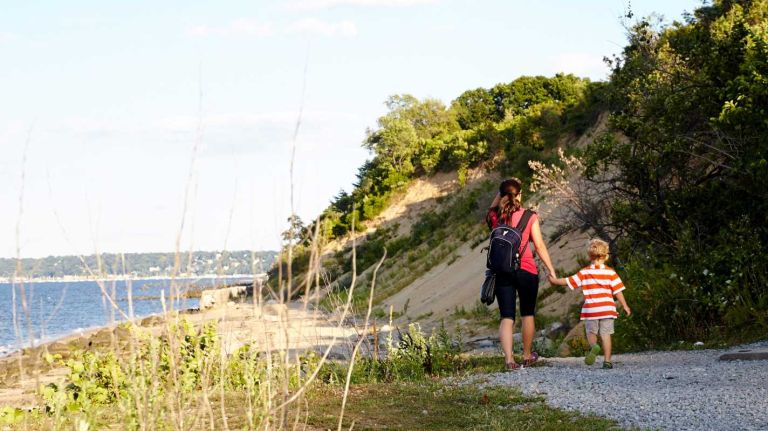 Tanya Kotsegyb and Isaac Taurevski of Sands Point walk along a trail at Sands Point Preserve in Port Washington. The preserve's six trails range from a quarter-mile to a full mile.
