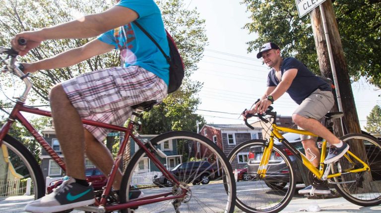 Cyclists ride down City Island Avenue in City Island on Friday, Sept. 5, 2014. 