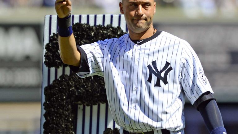 Yankees shortstop Derek Jeter waves to the crowd at Yankee Stadium during Derek Jeter Day on Sunday, Sept. 7, 2014