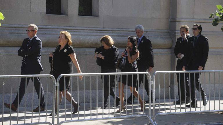 Mourners walk toward the entrance of Temple Emanu-El before a private funeral for the comedian in Manhattan on Sunday, Sept. 7, 2014. Joan Rivers died Sept. 4 at 81, days after going into cardiac arrest during an outpatient procedure.