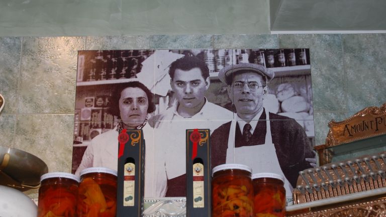 A portrait of Lou Di Palo's grandparents, Concetta and Luigi Santomauro and their son, his father, Savino, is on the wall at Di Palo's, a constant reminder of the history of the grocery - and its purpose. 