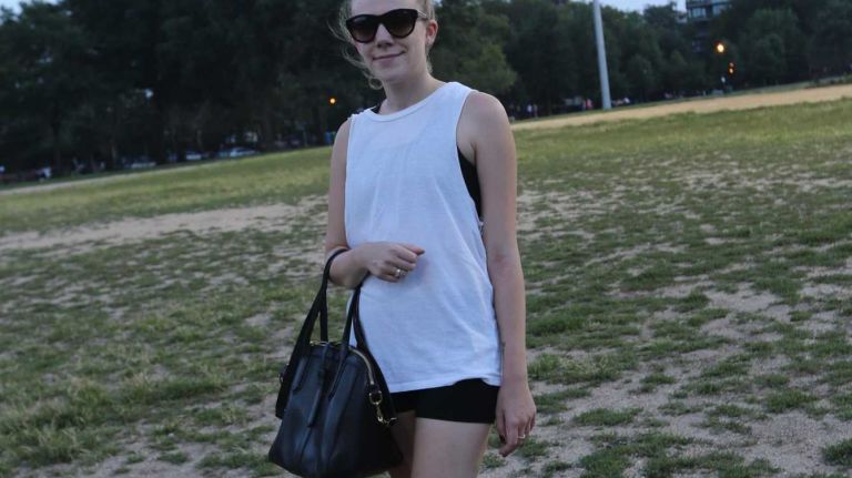 Michelle G., 29, of Manhattan, accessorizes her kickball outfit with sporty socks, gold sneakers and a cool pair of shades on a hot day in McCarren Park.