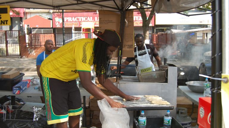 Festivals were being rolled at the Long Island Jamaican restaurant Yardies' stand on Eastern Parkway. The sweet fried dough is served alongside jerk chicken and rice and beans. 