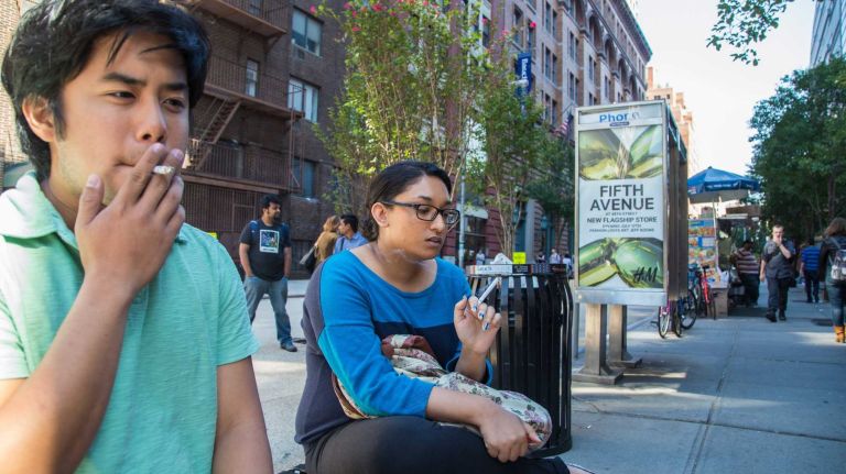 Christian Torre and Mina Bipat both of Queens smoke cigarettes in Manhattan on Monday Sept. 15, 2014.