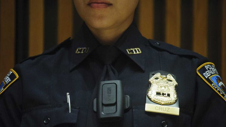 New York City Police Department Sergeant Andrea Cruz wears the Vievu LE3  camera during a news conference at One Police Plaza on September 04, 2014.  