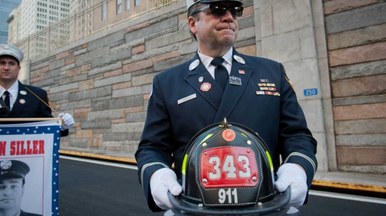 Firefighter Frank Hudec of Ladder 79 watches runners exit the Hugh L. Carey Tunnel on Sunday, Sept. 28, 2014, during the annual Stephen Siller Tunnel To Towers 5K Run & Walk that honors fallen 9/11 heroes.