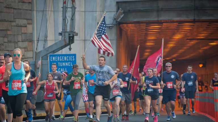 Runners exit the Hugh L. Carey Tunnel during of the 13th Annual Stephen Siller Tunnel To Towers 5K Run & Walk on Sunday, Sept. 28, 2014.