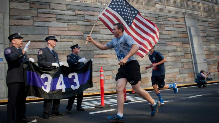 Runners exit the Hugh L. Carey Tunnel during the 13th Annual Stephen Siller Tunnel To Towers 5K Run & Walk on Sunday, Sept. 28, 2014.