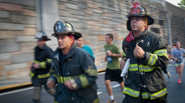 Runners exit the Hugh L. Carey Tunnel during the 13th Annual Stephen Siller Tunnel To Towers 5K Run & Walk on Sunday, Sept. 28, 2014.
