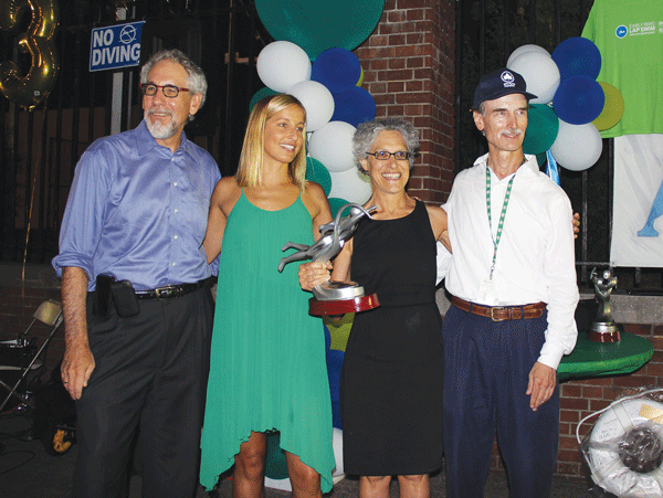 Anna Jardine, third from left, held her first-place overall women’s trophy, joined by, from left, Robert Farafola, Parks deputy commissioner for management, budget and public programs; emcee Kim Vandenberg, a bronze medalist in the 2008 Olympics in the women’s 4-x-200-meter freestyle relay; and John Hutchins, Parks aquatics director.  Photos by Tequila Minsky