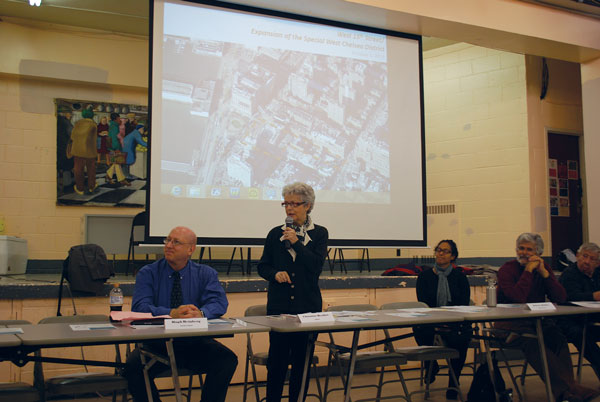 Photo by Winnie McCroy CB4 chair Christine Berthet (standing) and board members discussing the expansion of the Special West Chelsea District.