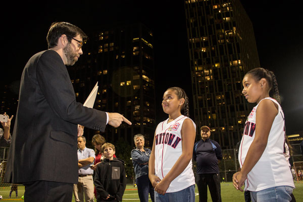 Downtown Express photo by Zach Williams. Downtown Little League pitcher Jamie Morrison celebrated in July after throwing to Anabella Pelaez (wearing a mask at first) for the final putout putting the 11u team in the state tournament, top. Pelaez and her sister Isabella, and the other players on Downtown’s state championship teams, were honored last week by State Sen. Daniel Squadron. 