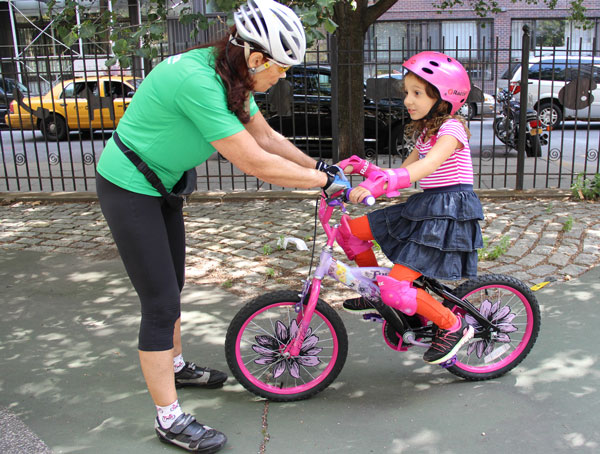 Instructor Cecilia Casey, of Bike New York, gave a young cyclist some pointers at the Mercer Playground event.  Photos by Tequila Minsky