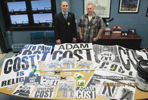 How the cops caught Cost in a sticky situation 1 Police with hundreds of Cost graffiti posters and stickers they allegedly found after a search of Adam Cole’s Porsche.