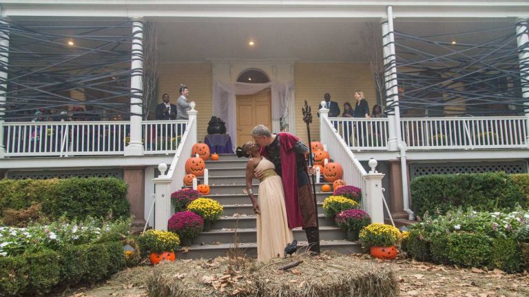 New York Mayor Bill de Blasio and First Lady Chirlane McCray kiss as they host Gracie Mansion's Halloween Open House on Tuesday, Oct. 28, 2014. The couple dressed in costumes inspired by Greek Mythology.