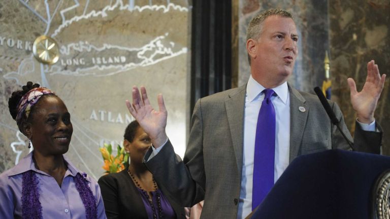 New York City Mayor de Blasio, right, is joined by First Lady Chirlane McCray, left, Mayor's Office to Combat Domestic Violence Commissioner Rose Pierre-Louis, center, during a news conference at the Empire State Building for NYC Go Purple Day on Wednesday, Oct. 15, 2014.