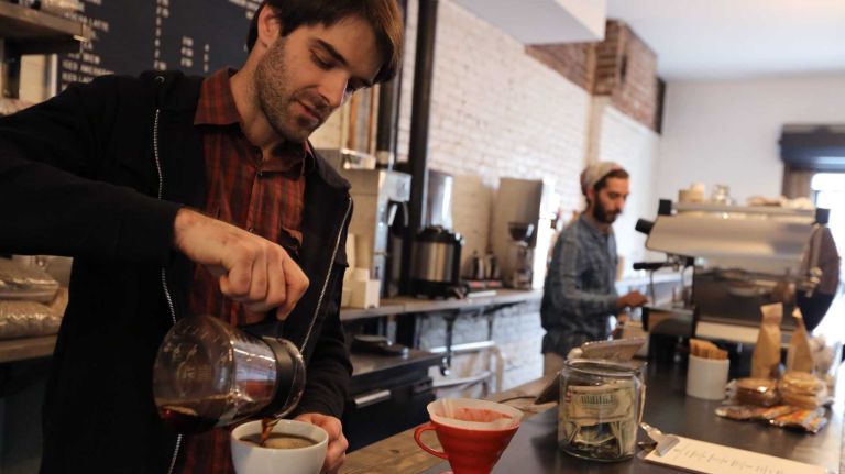 Taylor Mork, co-owner of Crop to Cup Coffee at 541A 3rd Ave. in Brooklyn, pours coffee on Oct. 2, 2014. 