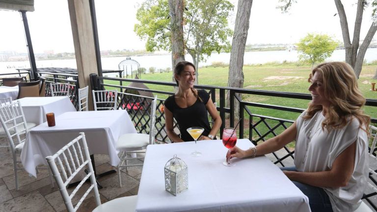 Christina Malerba, left, and Lori Russo have drinks on the porch at Angelina's Restaurant at 399 Ellis Street in Tottenville.