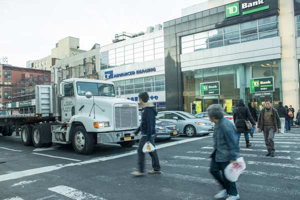 Heavy trucks on Canal St., such as at Bowery, above, mean the boulevard is at greater risk of fatalities, according to Councilmember Margaret Chin, victims’ family members and activists.   Photo by Zach Wiliams