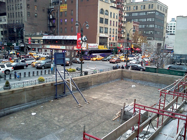 A Late Arrival, Yes, But Moynihan Station Construction Is On Track 4 Left photo: A sign links the Moynihan Station project to economic stimulus funds. Right photo: A view from the opposite side.