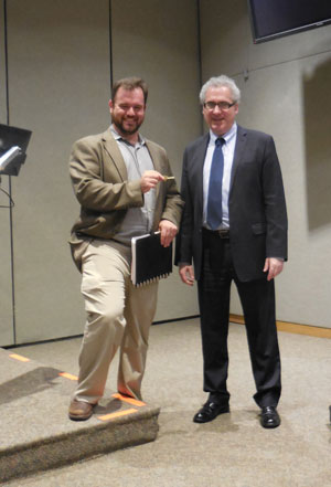New Face, Old Frustrations at CB4 1 Photo by Eileen Stukane Jesse Bodine receives the key to the CB4 office from former district manager Robert Benfatto.