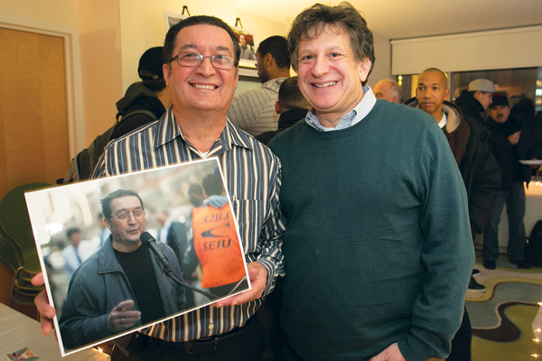 Courtesy of 32BJ William Rosado, porter at 520 W. 23rd St., poses with his photo. At right is the exhibit’s host, Lowell Kern. 