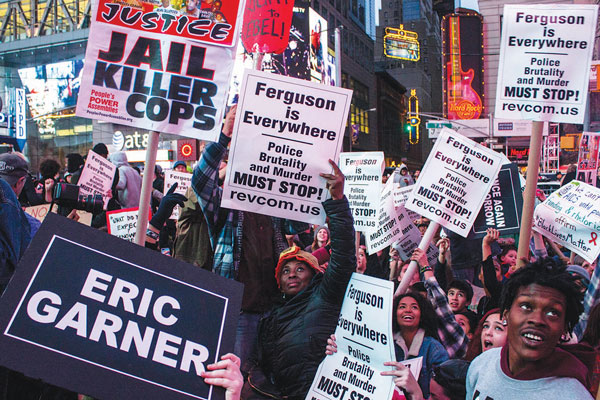 The marchers paused in Times Square to enjoy watching themselves on the big screen.   Photo by Zach Williams