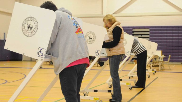 Voters turnout to cast their ballots Tuesday morning, Nov. 4, 2014, on Election Day at Hampton Bays Middle School in Hampton Bays. 