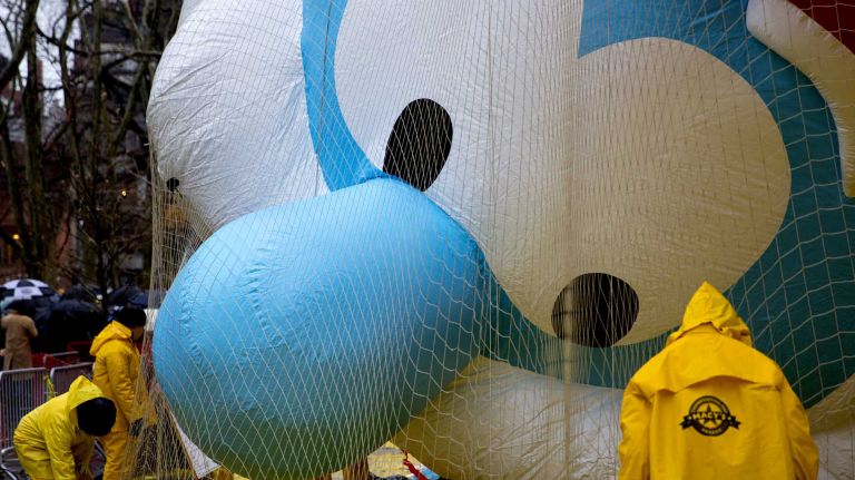 Macy's Thanksgiving Day Parade photos 13 The balloon Papa Smurf appears to keep an eye on workers as they prepare Macy's Thanksgiving Day Parade balloons by the Museum of Natural History near the parade route Wednesday, Nov. 26, 2014, in preparation for the decades old tradition of the Thanksgiving Day parade Thursday.