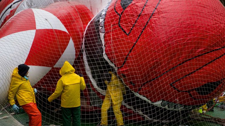 Macy's Thanksgiving Day Parade photos 22 One balloon worker seems to be in the mouth of Red Mighty Morphin Power Ranger as Macy's Thanksgiving Day Parade balloons are prepared and inflated by the Natural History Museum near the parade route Wednesday, Nov. 26, 2014, in preparation for the decades old tradition of the Thanksgiving Day parade Thursday.
