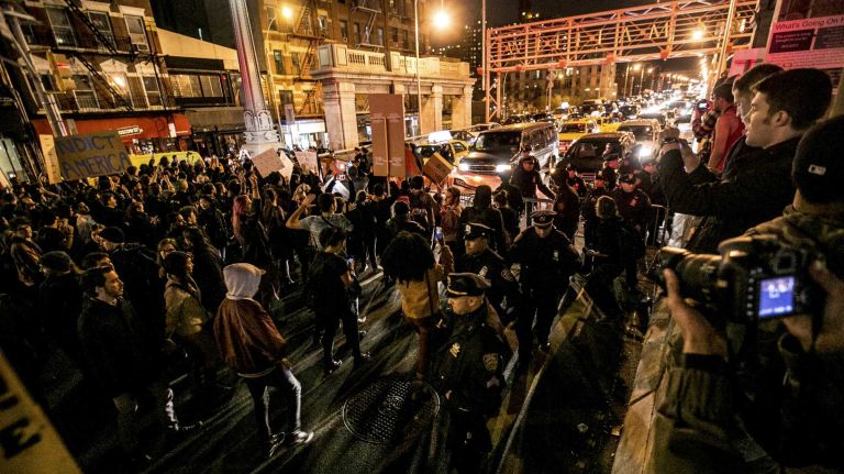 Protesters gather and block the base of the Williamsburg Bridge in Lower Manhattan on Tuesday, Nov. 25, 2014, in response to the grand jury decision regarding the fatal shooting of Michael Brown in Ferguson, Mo.
