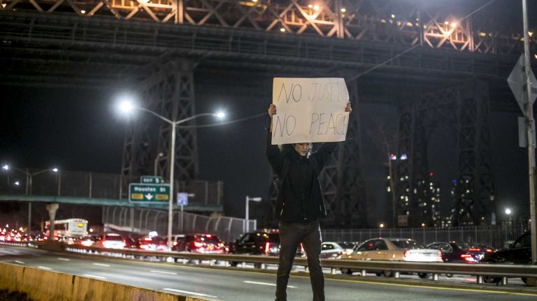 Protesters gather on FDR Drive in Lower Manhattan on Tuesday, Nov. 25, 2014, in response to the grand jury decision regarding the fatal shooting of Michael Brown in Ferguson, Mo.