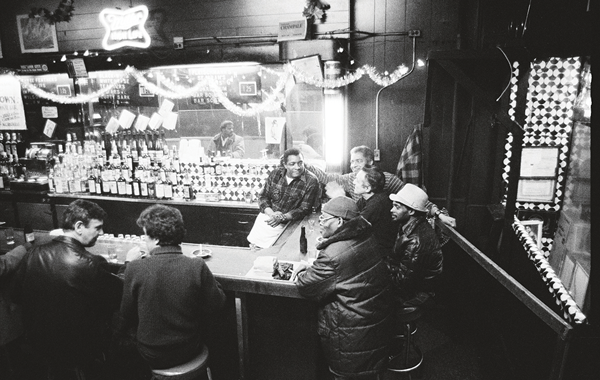 Jersey, bartending, with some of the regulars (1980).  Photo by Sheldon Nadelman