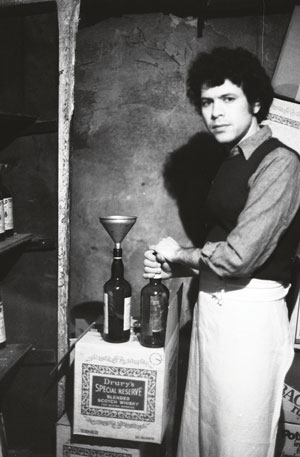 Sheldon “Shelly” Nadelman doing his “chemistry thing” (taking 86 proof Gordon’s Gin and replacing it with a clear, cheaper 86 proof). “Nobody ever knew the difference,” says Nadelman, who admits to duplicating the trick with Scotch, cognac and Rye whisky. This self-portrait was taken in 1973.