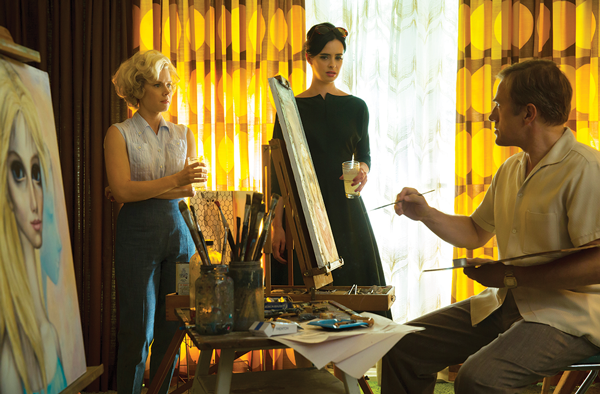 Burton’s weird, but not unwelcome, change of pace 1 (Con) Artist Walter Keane (Christoph Waltz) sits down to perform, as his artist wife (Amy Adams, left) and a friend (Krysten Ritter) look on. © 2014 The Weinstein Company. All rights reserved.