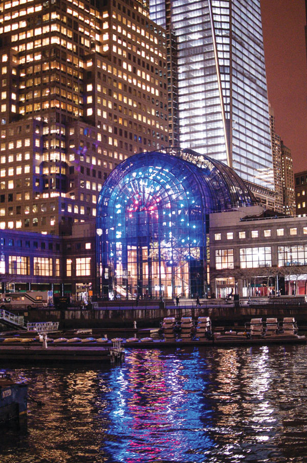 The 10-story light installation “Metamorphosis” shines over the Hudson River, and provides a backdrop for many of the holiday events at Brookfield Place.   Photo by Ryan Muir 